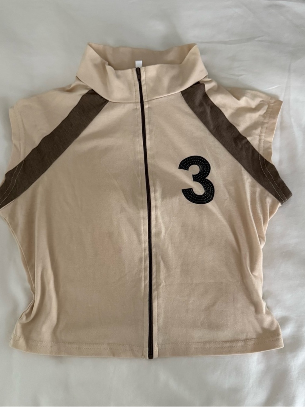 Sleeveless Beige Zip-Front Top with Brown Accents and Number 3